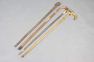 A piesel walking stick with corn handle, a walking stick with bone handle and 1 other 