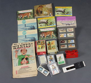 A Weetabix stereoscopic viewer and various cards, 7 albums of tea cards, various playing cards and 16 humorous posters 
