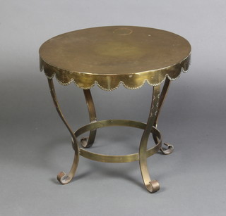 A 19th Century circular brass tea table with wavy border, raised on outswept supports 44cm x 49cm 
