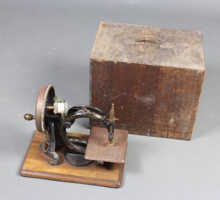 An early 19th Century manual sewing machine complete with carrying case 