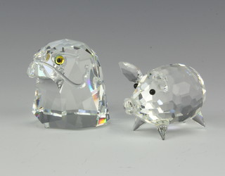 A Swarovski figure of a bird of prey 4cm and one other of a pig 3cm, boxed