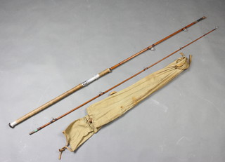 A Sharpes of Aberdeen "The Salmon Spinning" 9'3" impregnated split cane fishing rod with ferrule stopper, contained in a Milbo cloth bag 
