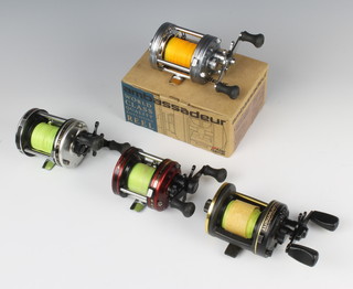 An Abu Ambassadeur 6500-C3 fishing reel, an Abu Ambassadeur 5000 fishing reel, an Abu Ambassadeur 6500-C3 fishing reel boxed together with a Millionaire Tournament fishing reel 