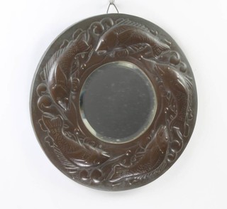 A Newlyn circular copper mirror frame with bevelled plate mirror to the centre decorated fish and signed Newlyn 40cm 