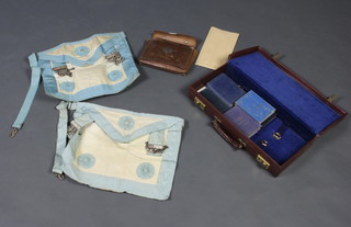 A Masonic case containing 2 Master Masons aprons and various books 