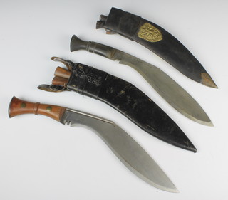 A Kukri with 30cm blade and hardwood handle, 2 skinning knives complete with scabbards and 1 other Kukri with 29.5cm blade, horn handle and leather scabbard 