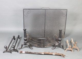 A pair of 19th Century cast iron fire dogs in the form of columns 19cm x 31cm together with associated baskets 34cm x 76cm, a metal ash tray, a wrought iron mesh spark guard 75cm x 101cm x 16cm, 2 pairs of iron fire dogs and four fire irons  