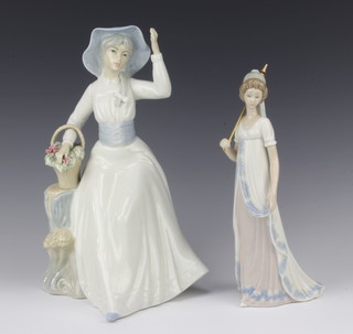 A Lladro figure of a standing lady with parasol (parasol f) 25cm and one other Valencia a bonneted lady with basket flowers 30cm  