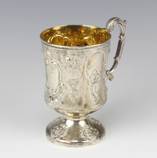 A Victorian repousse silver baluster mug decorated with flowers and classical figures with a waisted stem and S scroll handle, London 1879, maker George W Adams, 12cm, 210 grams 