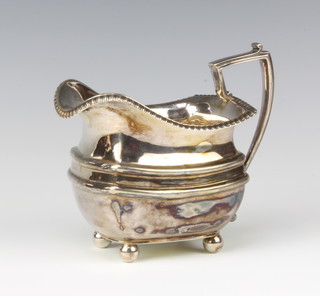 A Victorian silver cream jug with egg and dart decoration on ball feet Sheffield 1896, made by James Dixon and Sons 9cm, 215 grams 
