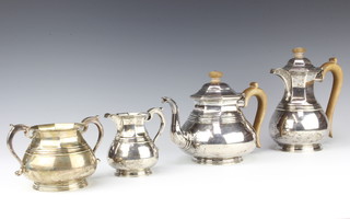 A silver 4 piece tea and coffee set of bulbous form with octagonal panels, having fruitwood handles London 1926, maker Richard Comyns, gross 62 ozs or 6203 grams 