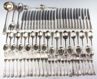 A Victorian matched silver canteen of Kings pattern cutlery comprising 22 dessert forks, 14 dinner forks, 11 table spoons, 11 dessert spoons, 2 small ladles, 1 large ladle, serving spoon and fork, mixed dates London 1822/1869/1886, 5478 grams together with 12 modern dessert knives, 12 ditto dinner knives and a plated dinner fork 