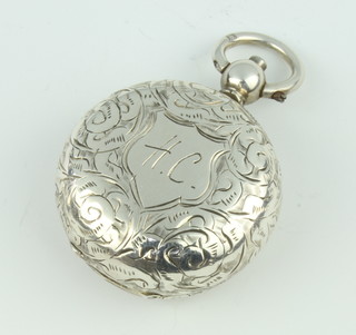 A Victorian circular silver sovereign case with chased scroll decoration and monogram Birmingham 1895 
