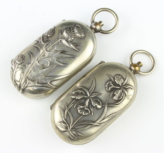 An Art Nouveau silver plated repousse sovereign and half sovereign case decorated with irises, a ditto decorated with thistles