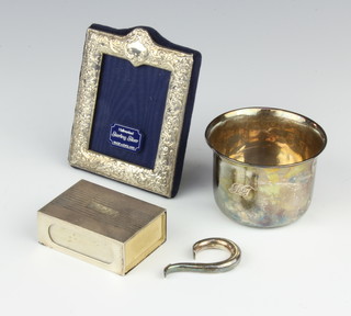 A silver engine turned matchbox holder, a photo frame and cup 