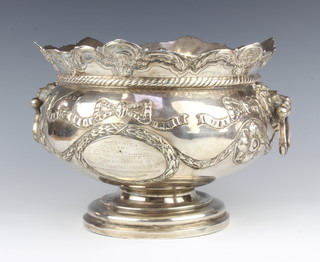 An Edwardian repousse silver punch bowl with floral swags and festoons having lion ring handles Birmingham 1908, 18cm, 1013 grams