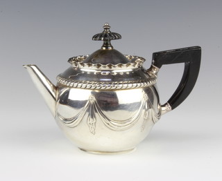 A Victorian silver batchelor's teapot with repousse decoration and ebony mounts London 1886, gross weight 216 grams 