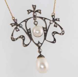 A silver gilt Edwardian style pearl and diamond open pendant on a chain 