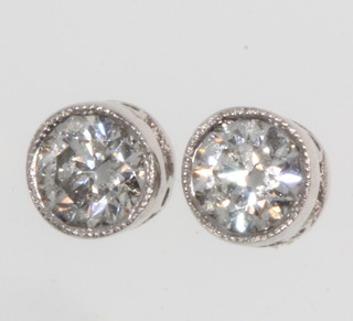 A pair of 18ct white gold single stone diamond ear studs, approx 0.67ct