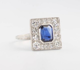An 18ct white gold Art Deco style sapphire and diamond cluster ring size N, the centre sapphire approx. 1ct 