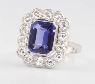 An 18ct white gold octagonal cut tanzanite and diamond cluster ring, the centre stone approx. 2.8ct surrounded by brilliant cut diamonds approx. 1.4ct, size N 1/2