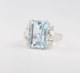 An 18ct white gold aquamarine and diamond ring, the centre stone approx. 6.65ct surrounded by baguette cut diamonds 0.4ct and brilliant cut diamonds 0.3ct, size N 