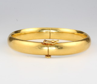 A Chinese 21ct yellow gold bangle, 39 grams