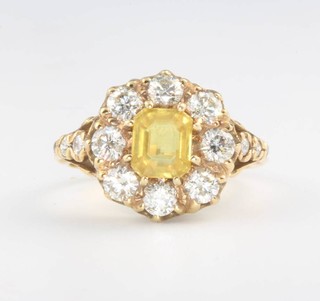 An 18ct yellow gold yellow sapphire and diamond cluster ring, the centre stone 1.3ct surrounded by brilliant cut diamonds approx. 1.7ct, size O 