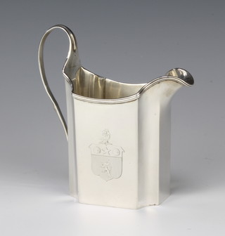 A George III silver cream jug with chased armorial and S scroll handle, London 1793, rubbed marks 182 grams