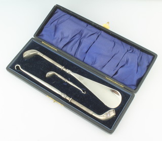 An Edwardian novelty silver mounted shoe horn, glove hook and boot hook in the form of golf woods, Birmingham 1907, in a fitted case 