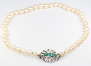 A single strand of cultured pearls with a diamond and emerald set clasp 43.5cm 
