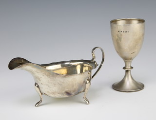 A silver sauce boat with S scroll handle on pad feet, Sheffield 1947 and a silver trophy cup Birmingham 1921 163 grams 