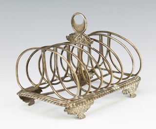 A George IV silver 7 bar toast rack raised on scroll feet London 1827, and a pair of pepperettes 295 grams