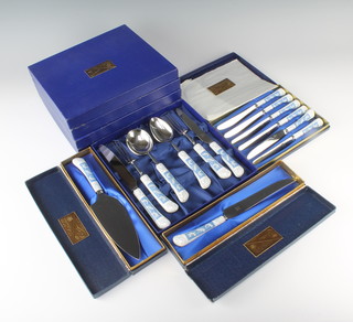 A collection of cutlery with Coalport revelry pattern porcelain handles comprising 5 cased place settings, a cased set of 6 knives, a boxed cake slice and a boxed bread knife