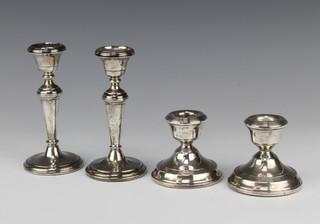 A pair of silver dwarf tapered candlesticks Birmingham 1986, 13cm, a ditto Birmingham 1973, 7cm