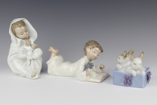 4 Nao figures - child 19cm, child reading with a dog 10cm and 2 rabbits 10cm 

