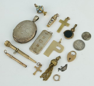 A silver ingot, minor gold and other charms etc 