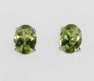 A pair of oval peridot ear studs 1.2ct 