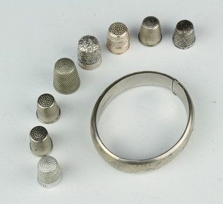 A silver bangle, 2 silver thimbles and 6 others 