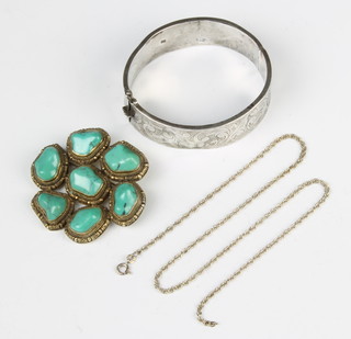 A silver bangle, a brooch and pendant