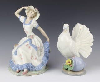 A Nao figure of a seated bonnetted lady 25cm together with a Spanish figure of a dove 