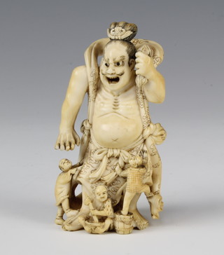 A Japanese Meiji period okimono of a giant with 4 figures standing at his feet, signed, 9cm 