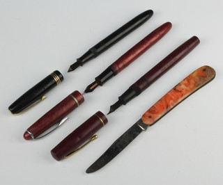 An Osmiroid pink marble fountain pen, a black Burnham ditto and a red Stevens ditto together with a Bakelite penknife 