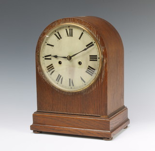 Hamburg American Clock Co. a striking mantel clock with silvered dial contained in an oak arch shaped case with pendulum  (no key) 
