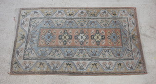 A Caucasian style rug with turquoise ground 205cm x 120cm