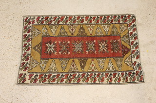 A Caucasian style rug with tan and cream ground and central medallion 135cm x 89cm 