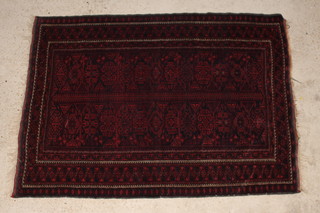 A red and blue ground Belouche rug with central medallion within multi row borders 188cm x 134cm 