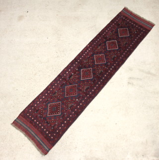 A blue and red Meshwani runner with 6 diamonds to the centre within a multi row border 267cm x 65cm 