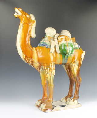 A Chinese Tang style slip glazed figure of a camel raised on a rectangular base 70cm