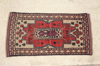 A tan and brown ground Baluchi rug with central medallion 135cm x 72cm 